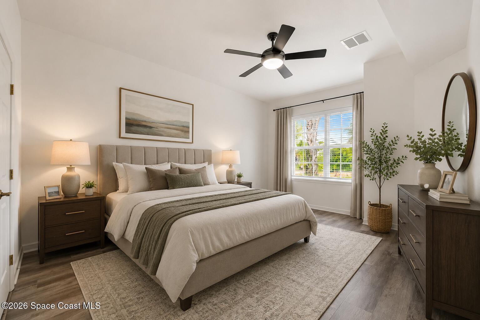 110 Turpial Way, Unit 106 Melbourne, FL 32901 - Photo 20 of 50 a bedroom with a large bed and a chandelier