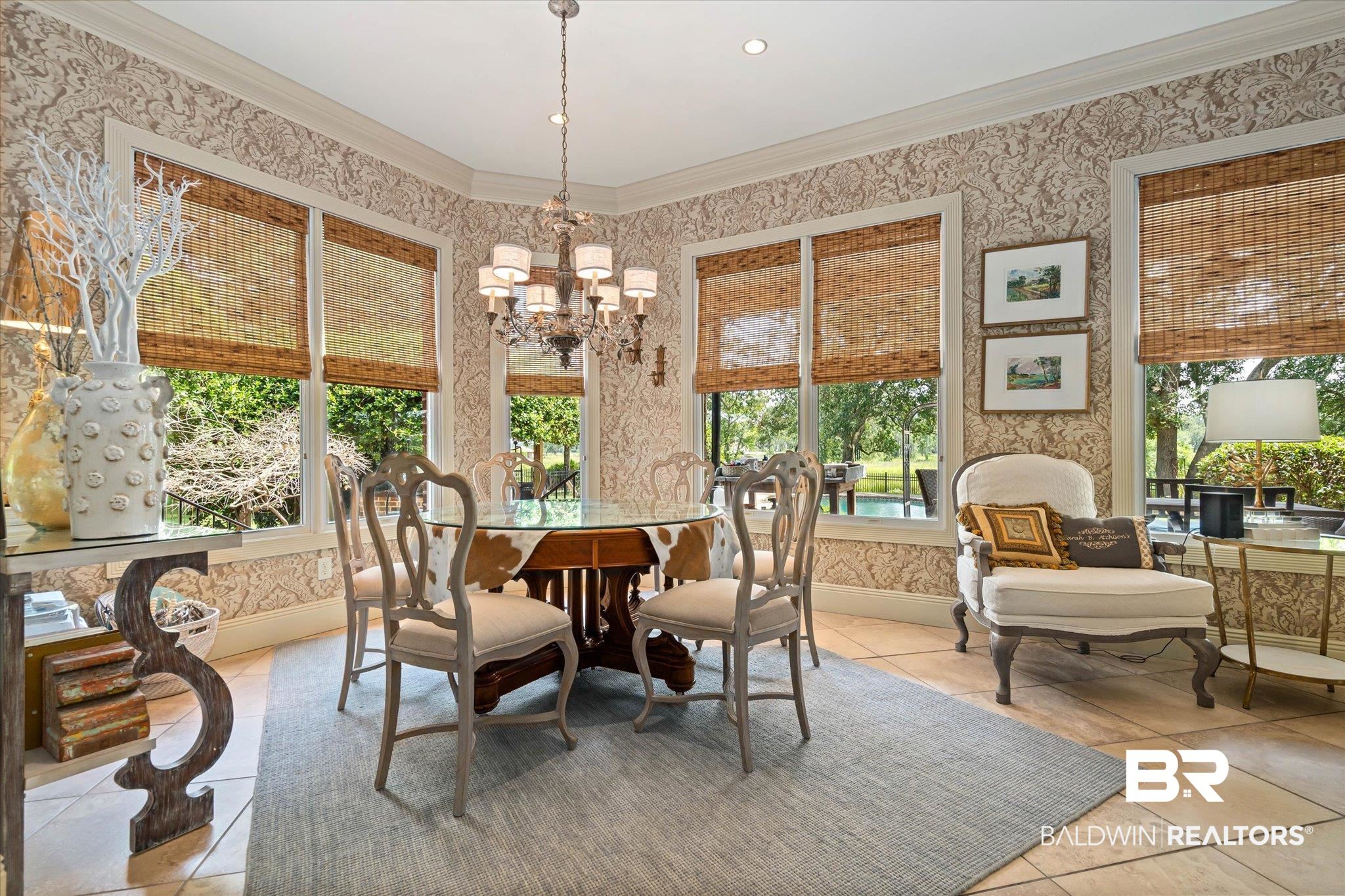 2905 Riverview Pointe Drive South Theodore, AL 36582 - Photo 9 of 44 Dining area with wallpapered walls, crown molding, and hanging lights