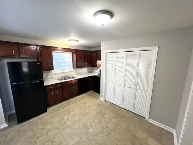 a kitchen with a refrigerator and a sink