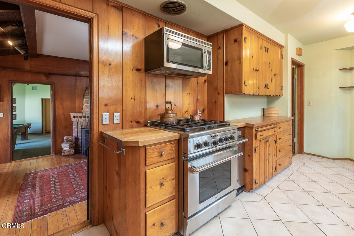 424 North Old Ranch Road Arcadia, CA 91007 - Photo 17 of 54 a kitchen with stainless steel appliances granite countertop a stove a sink and a microwave