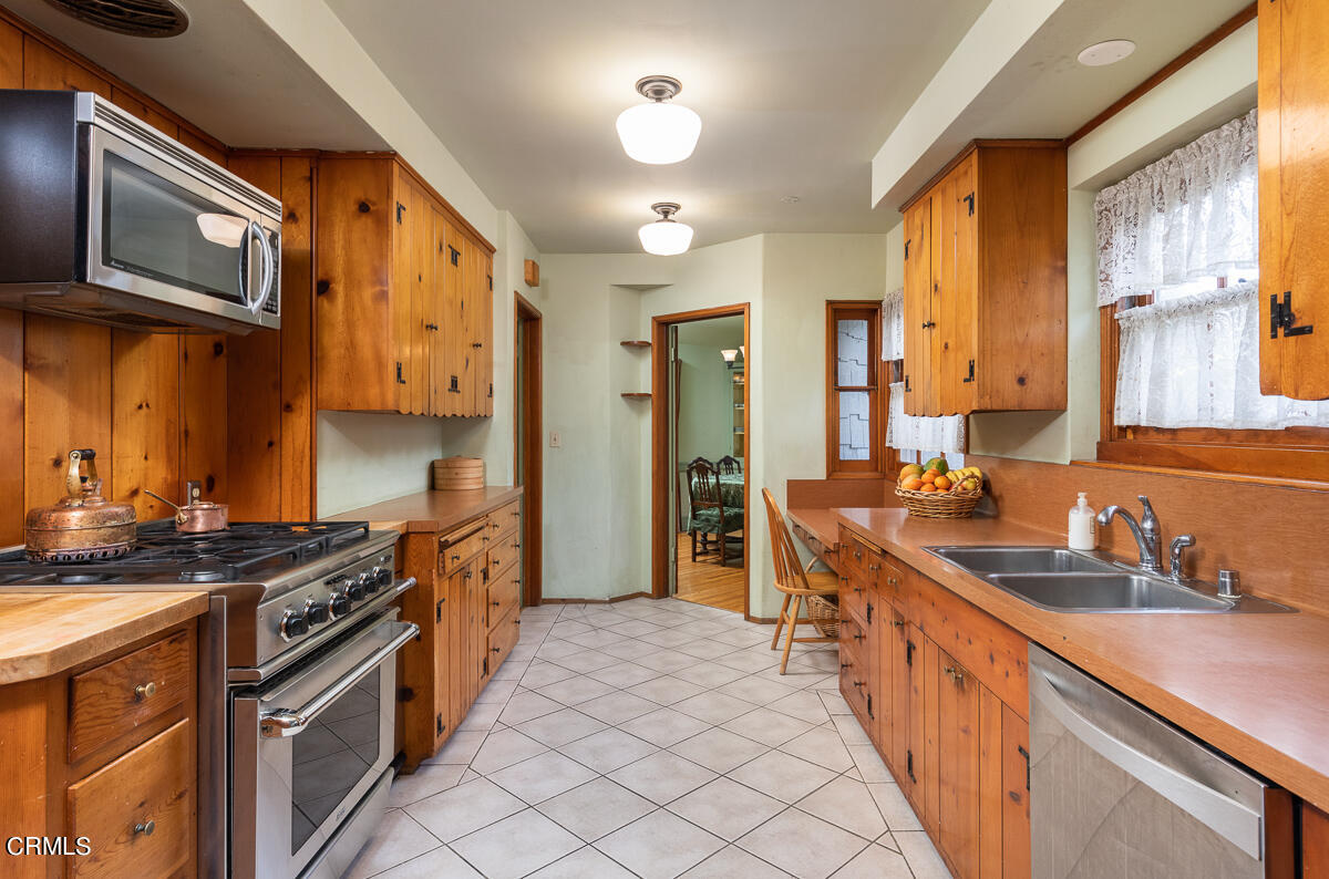 424 North Old Ranch Road Arcadia, CA 91007 - Photo 18 of 54 a kitchen with stainless steel appliances a sink stove and cabinets