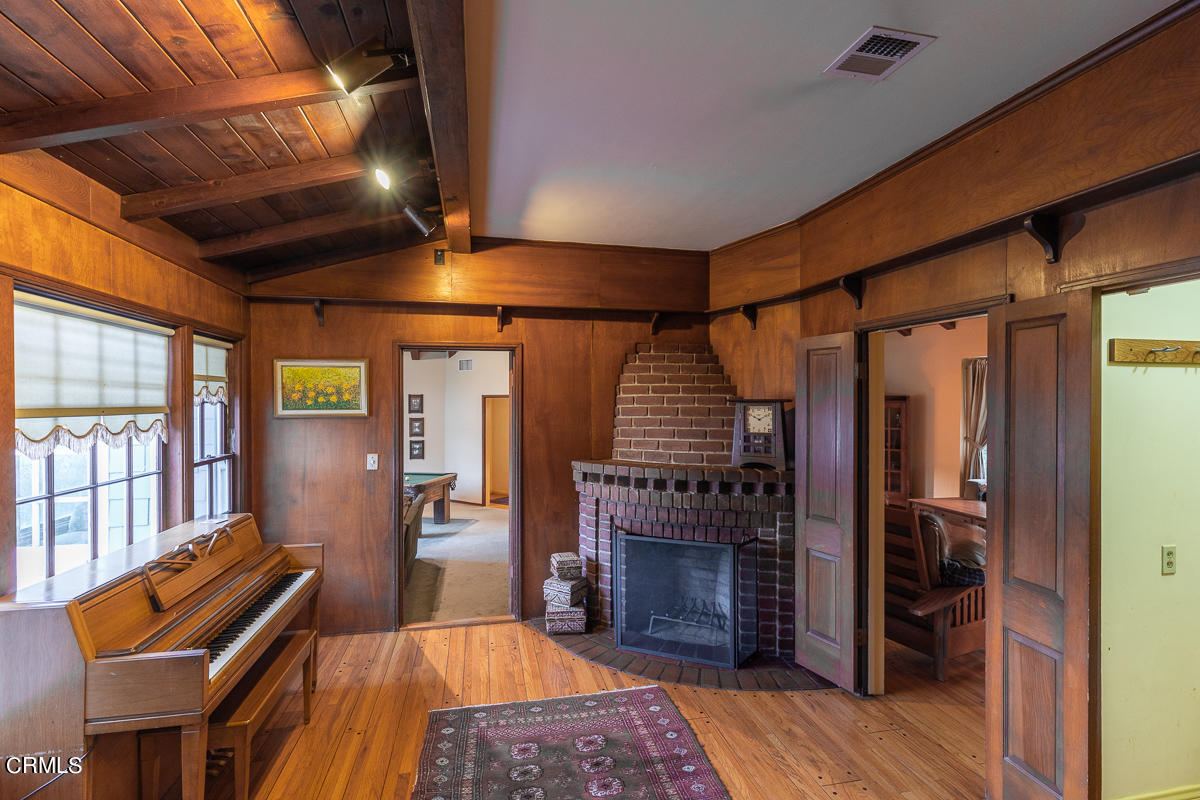 424 North Old Ranch Road Arcadia, CA 91007 - Photo 24 of 54 a living room with furniture a ceiling fan and a fireplace