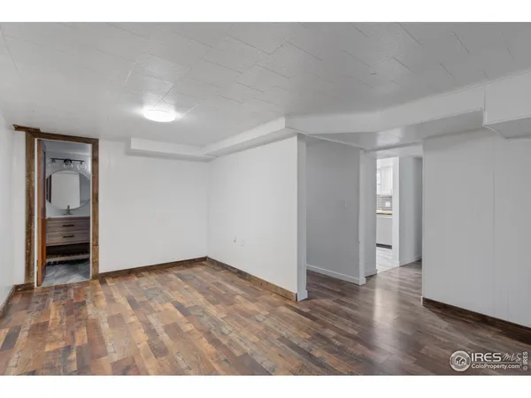 a view of an empty room and wooden floor