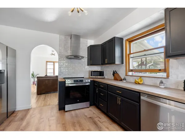 a kitchen with stainless steel appliances granite countertop a sink and a microwave