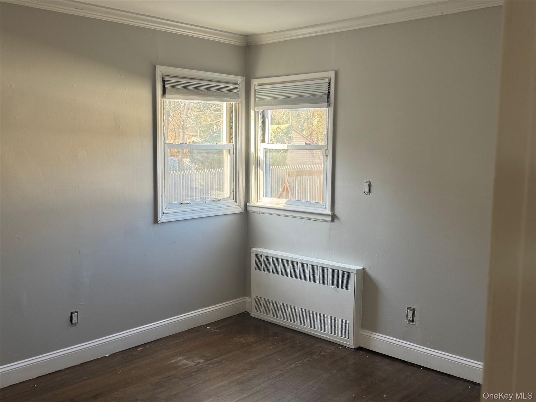 1239 August Road North Babylon, NY 11703 - Photo 11 of 16 a view of an empty room with wooden floor and a window