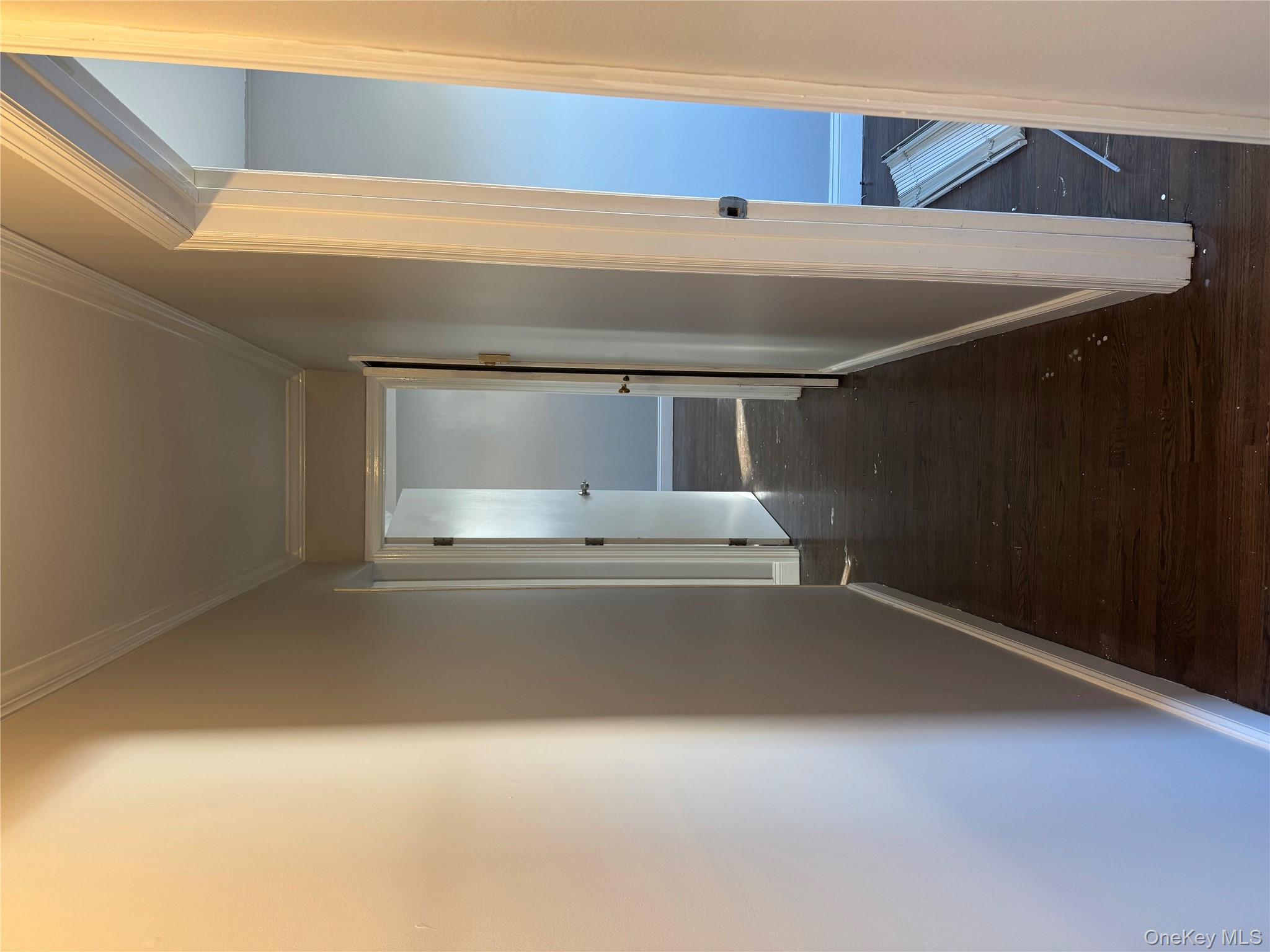 1239 August Road North Babylon, NY 11703 - Photo 13 of 16 a view of a hallway with wooden floor