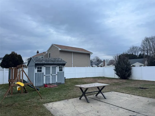 a backyard of a house with table and chairs
