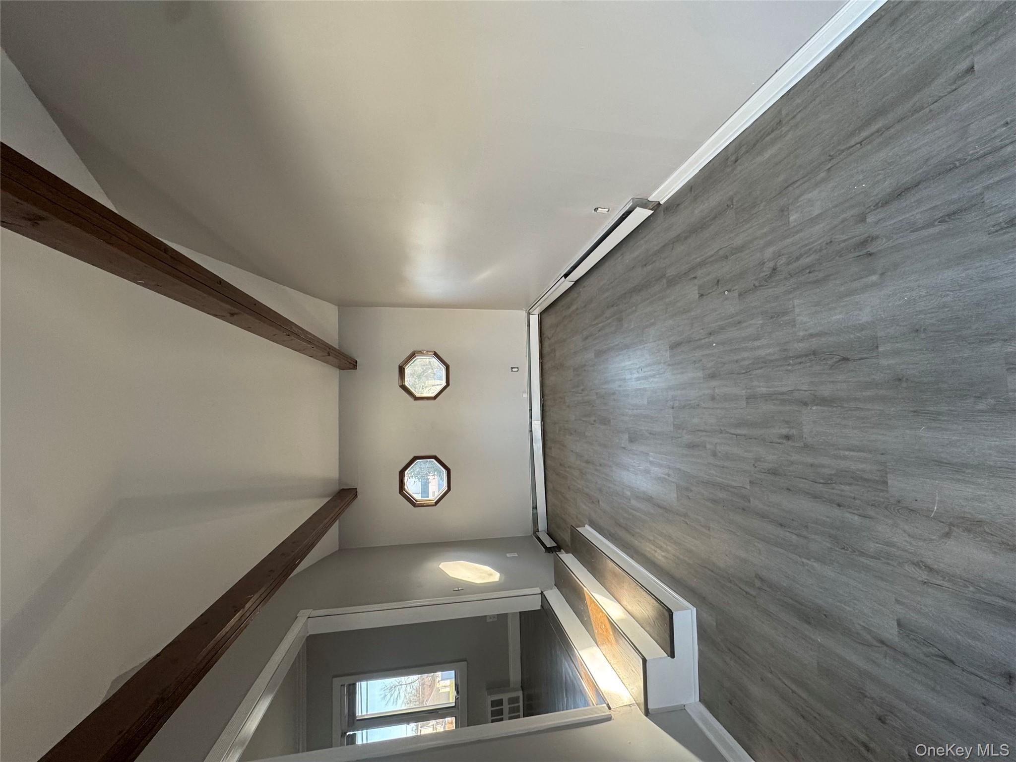 1239 August Road North Babylon, NY 11703 - Photo 7 of 16 a view of an empty room with wooden floor and a window