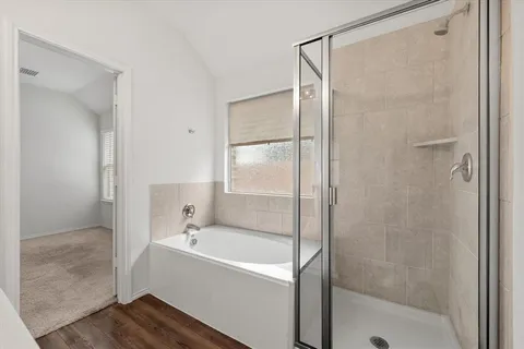 a bathroom with a bathtub and a shower