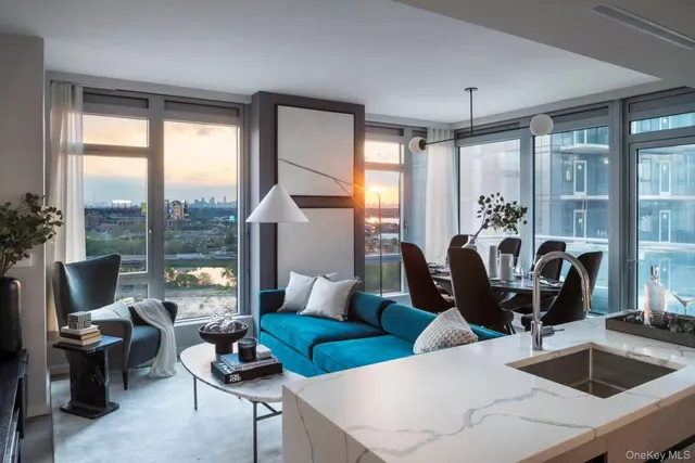 a living room with furniture and large windows