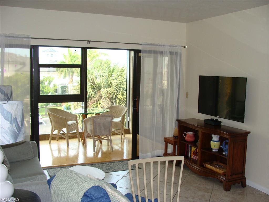 807 River Point Drive, Unit 201D Naples, FL 34102 - Photo 11 of 31 a living room with furniture and a flat screen tv
