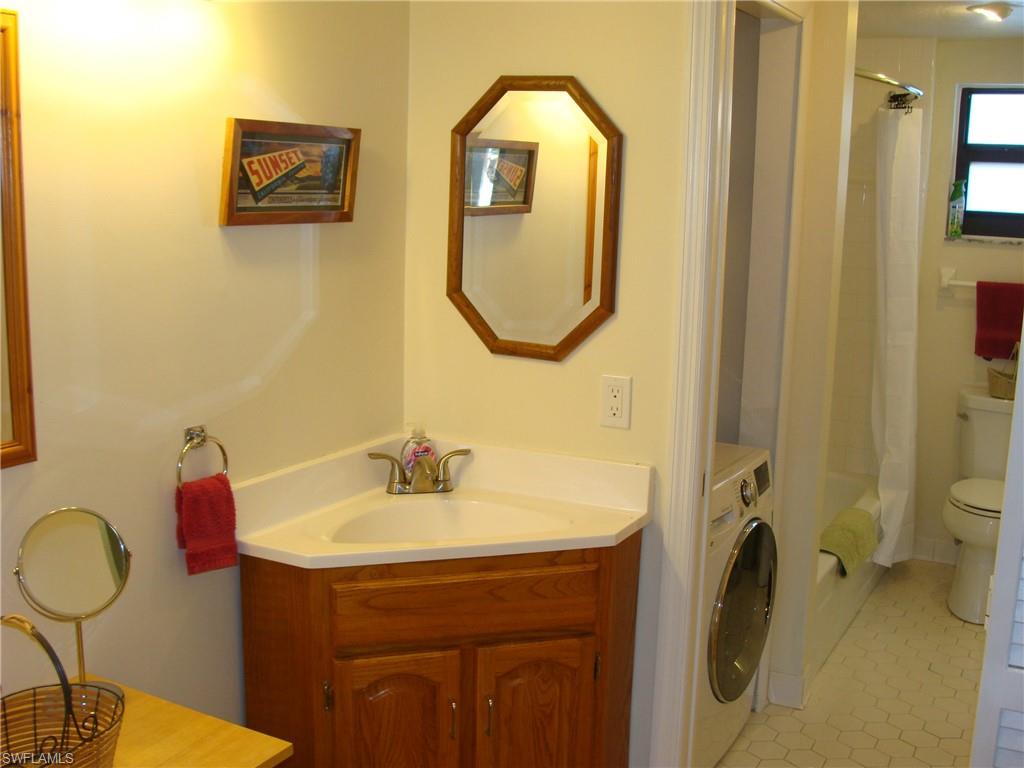 807 River Point Drive, Unit 201D Naples, FL 34102 - Photo 15 of 31 a bathroom with a sink mirror and toilet