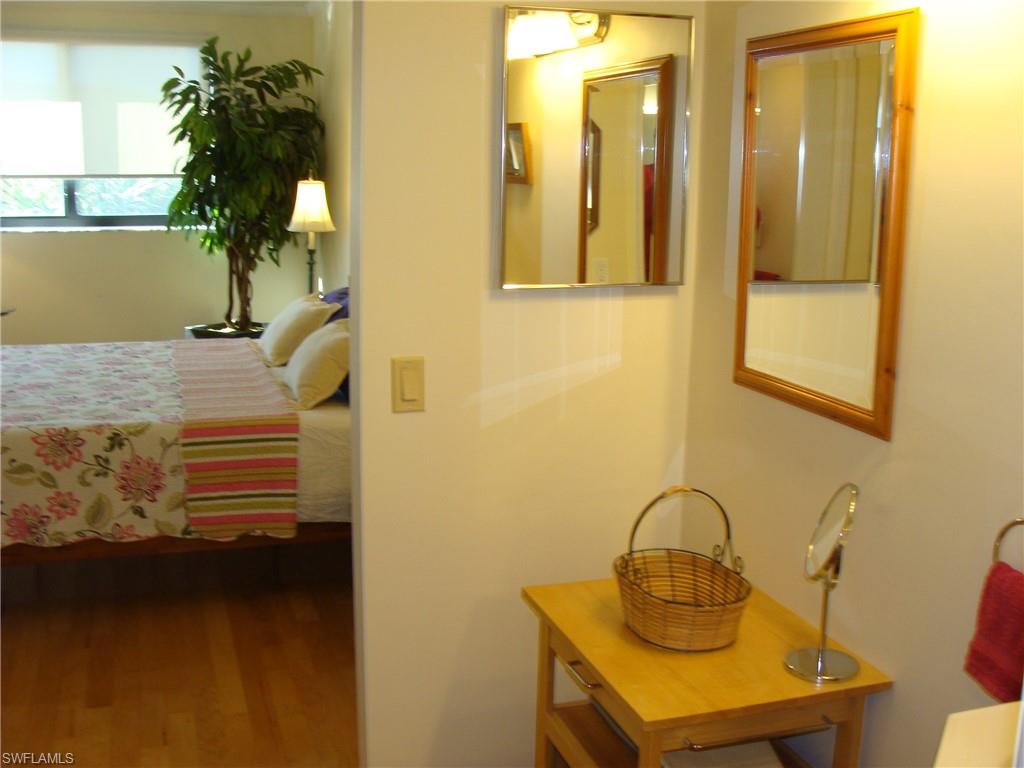 807 River Point Drive, Unit 201D Naples, FL 34102 - Photo 16 of 31 a bathroom with a sink a mirror and potted plant