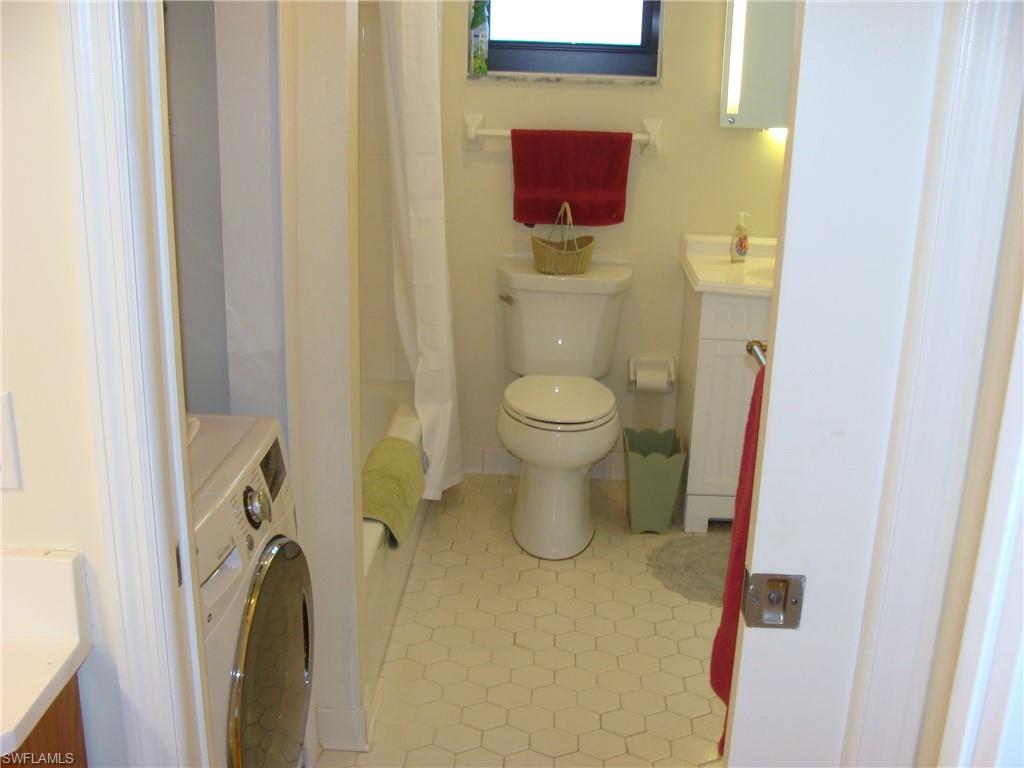 807 River Point Drive, Unit 201D Naples, FL 34102 - Photo 19 of 31 a bathroom with a toilet and a sink