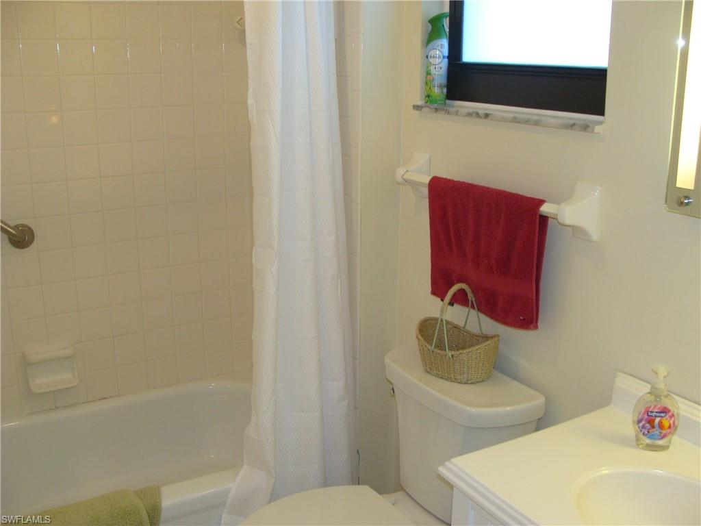 807 River Point Drive, Unit 201D Naples, FL 34102 - Photo 20 of 31 a bathroom with a toilet sink and mirror