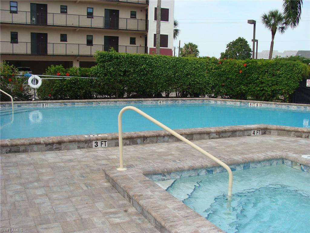 807 River Point Drive, Unit 201D Naples, FL 34102 - Photo 21 of 31 a view of a swimming pool with a yard