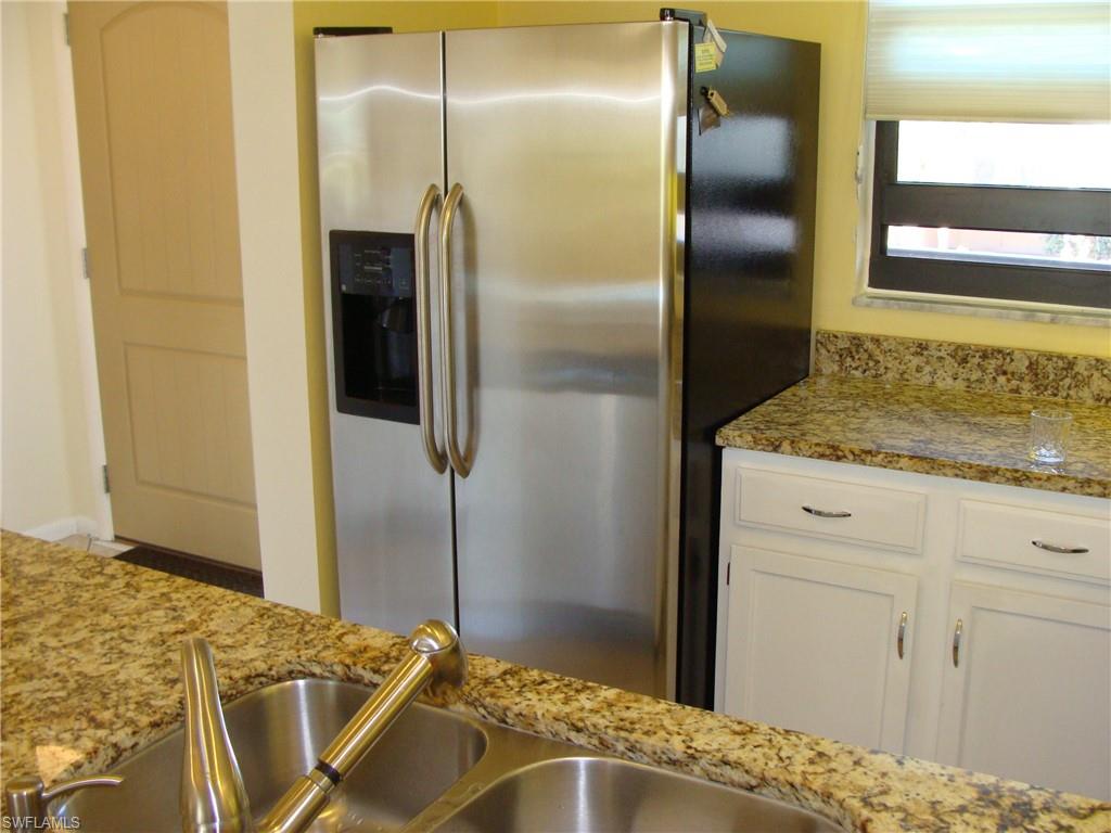 807 River Point Drive, Unit 201D Naples, FL 34102 - Photo 5 of 31 a bathroom with a granite countertop sink and shower