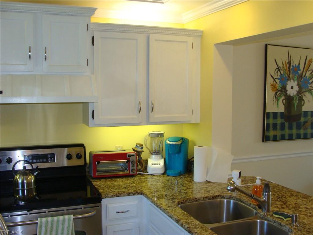 807 River Point Drive, Unit 201D Naples, FL 34102 - Photo 6 of 31 a kitchen with a sink and cabinets