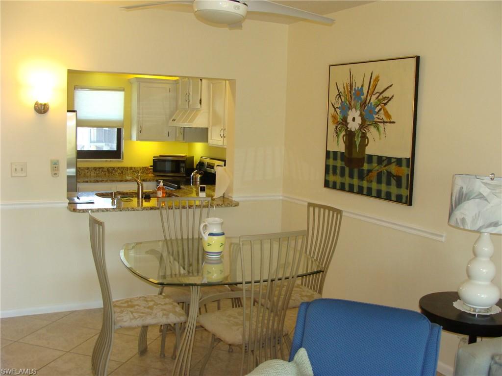 807 River Point Drive, Unit 201D Naples, FL 34102 - Photo 7 of 31 a dining room with furniture and wooden floor