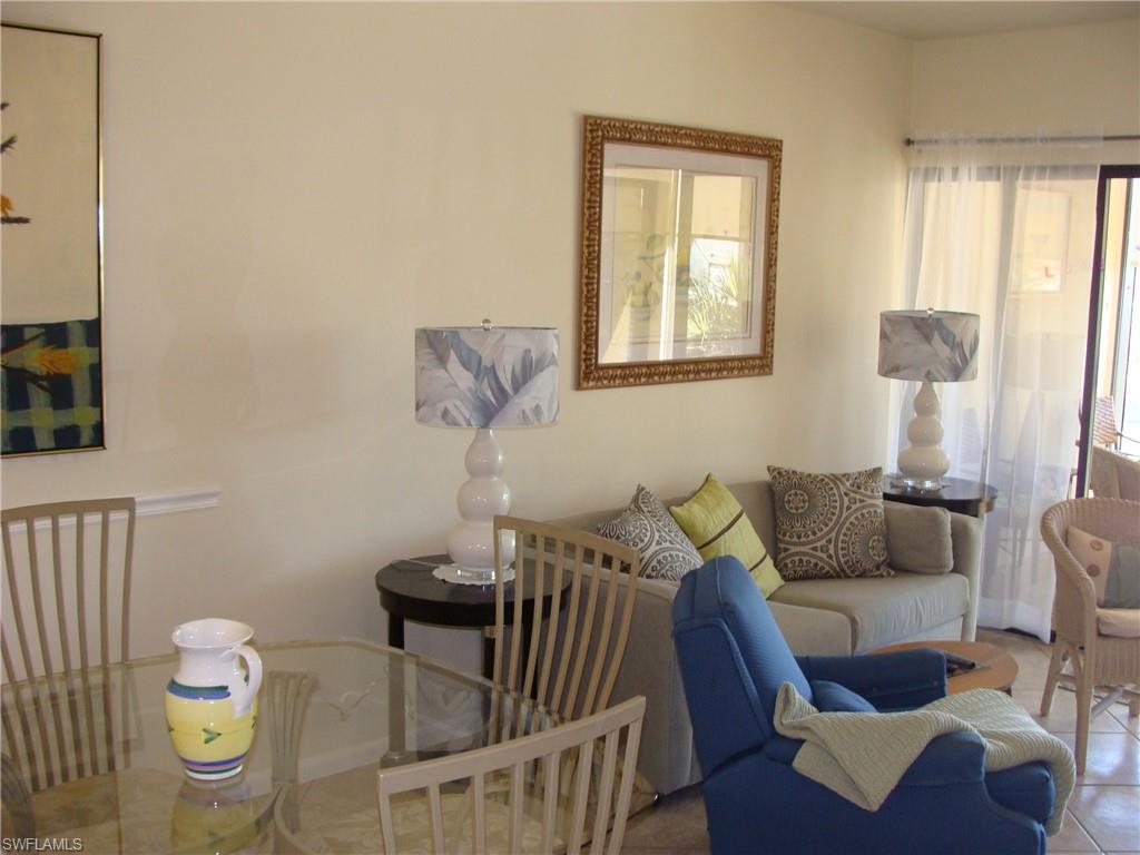 807 River Point Drive, Unit 201D Naples, FL 34102 - Photo 8 of 31 a living room with furniture and wooden floor