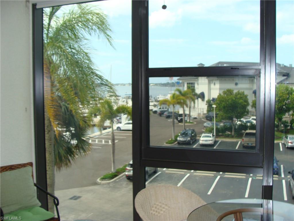 807 River Point Drive, Unit 201D Naples, FL 34102 - Photo 9 of 31 a view of a balcony with floor to ceiling windows with wooden floor