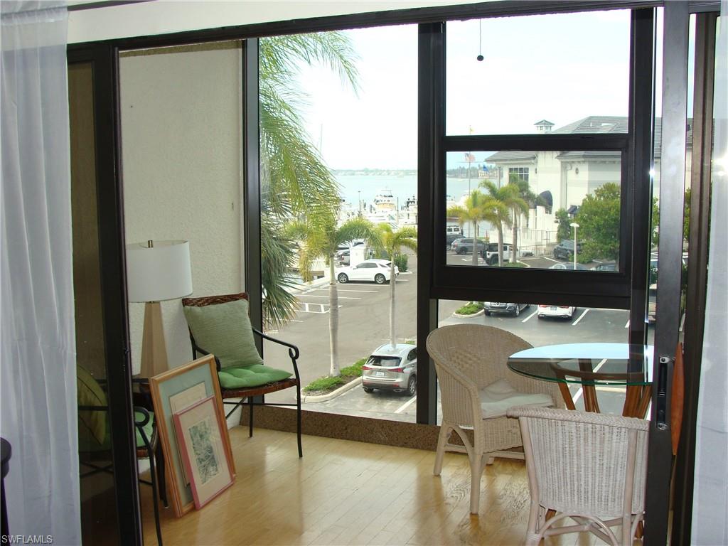 807 River Point Drive, Unit 201D Naples, FL 34102 - Photo 10 of 31 a living room with furniture and a large window
