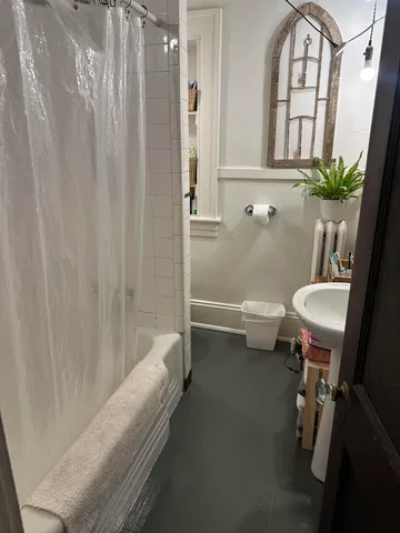 a living room with furniture fireplace and a window