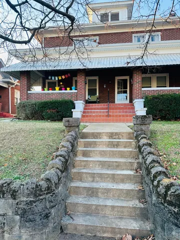 a front view of a house with a yard table and chairs