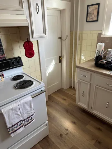 a view of a room with furniture and wooden floor
