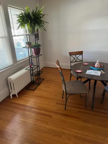 a view of living room with furniture and a potted plant