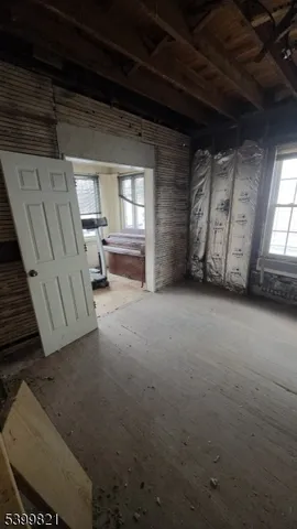 a view of a livingroom with furniture and a window