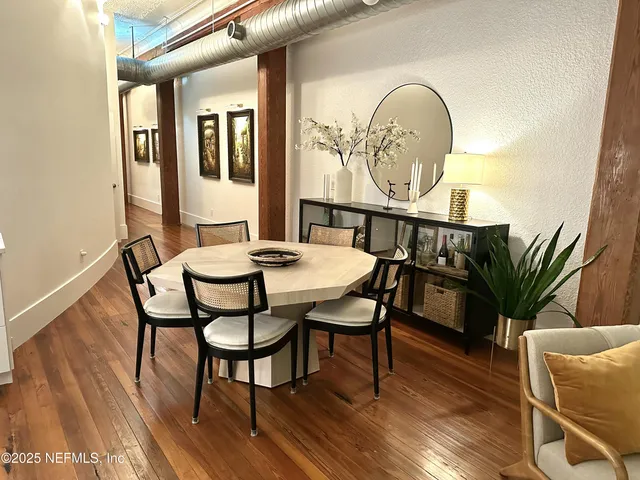 a view of a dining room with furniture window and wooden floor