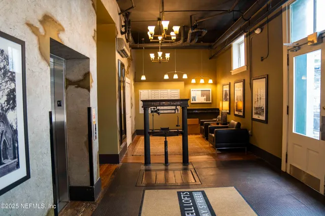 a view of a lobby with furniture and a chandelier