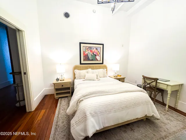 a bedroom with a bed and a table