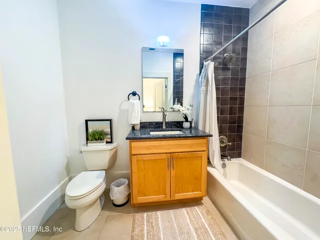 a bathroom with a toilet a sink and bathtub