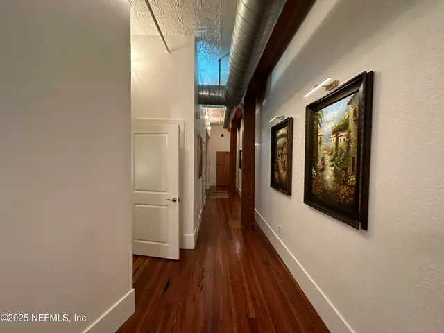 a view of hallway with wooden floor