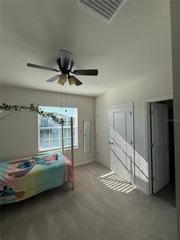 a bedroom with furniture and a chandelier