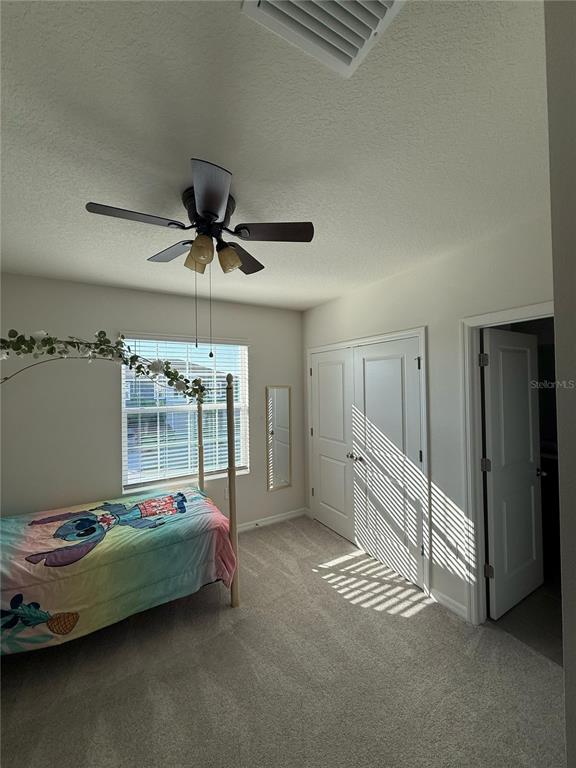 16177 Glowing Grove Avenue Odessa, FL 33556 - Photo 4 of 13 a bedroom with furniture and a chandelier