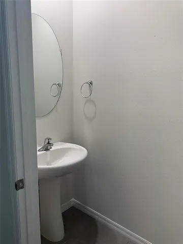 a bathroom with a sink and mirror