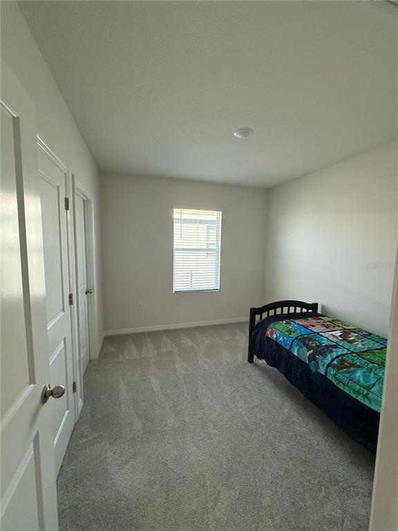 16177 Glowing Grove Avenue Odessa, FL 33556 - Photo 7 of 13 an empty room with windows