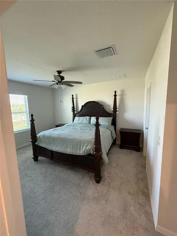 a bedroom with a bed and a table