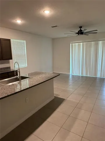 a view of a kitchen with a sink and a window