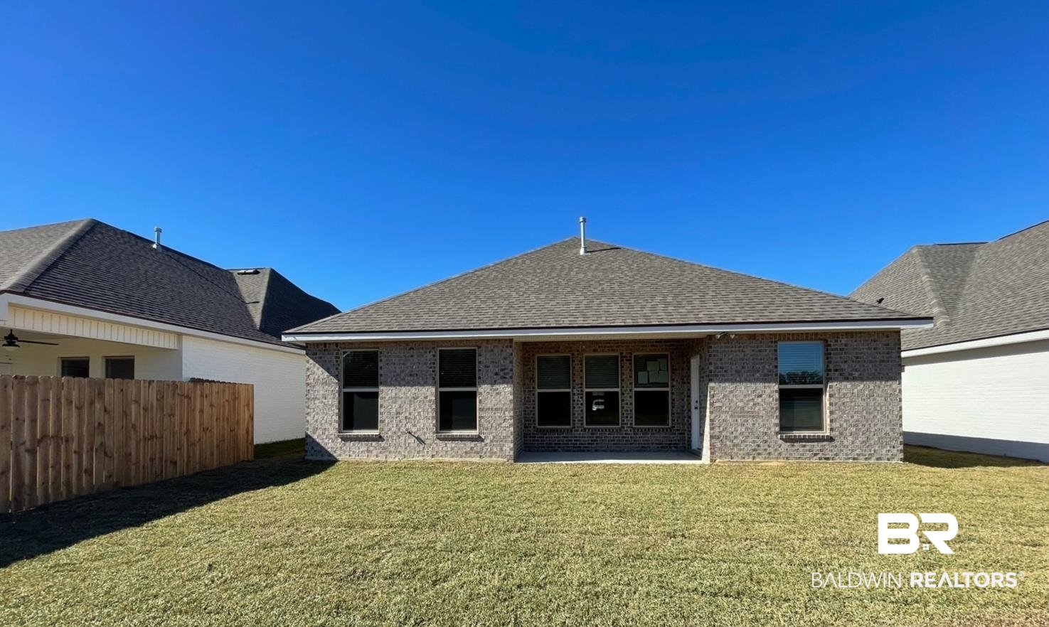 1396 Fenton Circle Foley, AL 36535 - Photo 12 of 14 Back of house featuring a lawn