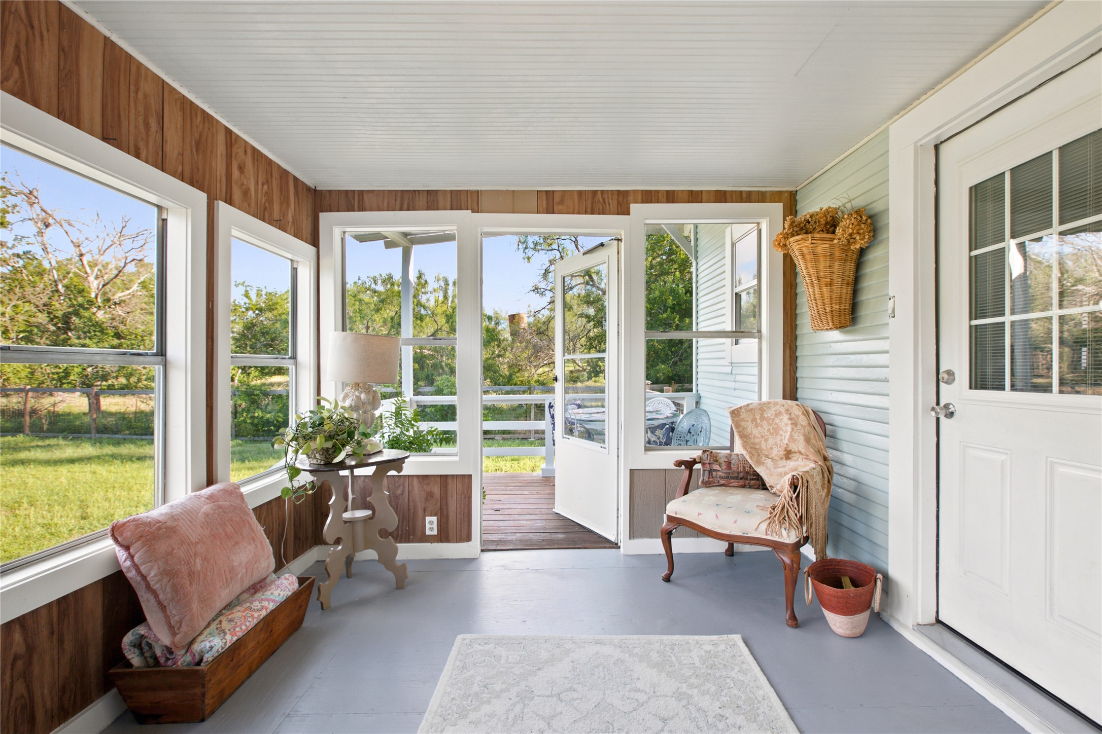 372 Old Lockhart Road Lockhart, TX 78644 - Photo 30 of 40 A tranquil sunroom welcomes you, offering views of the spacious backyard and access to the outdoor deck.