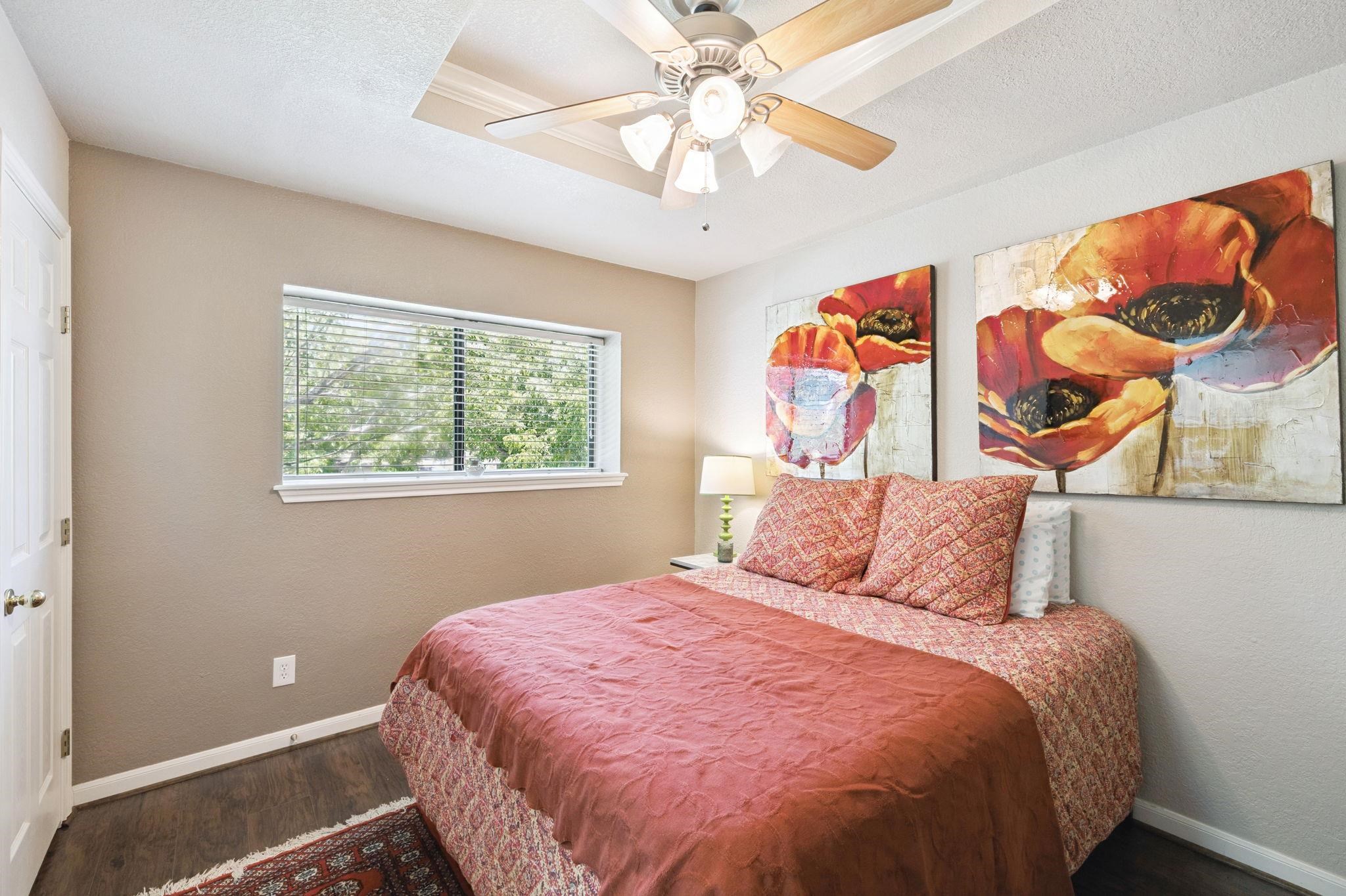 1435 East Zipp Road New Braunfels, TX 78130 - Photo 37 of 43 a bedroom with a bed and a painting on the wall