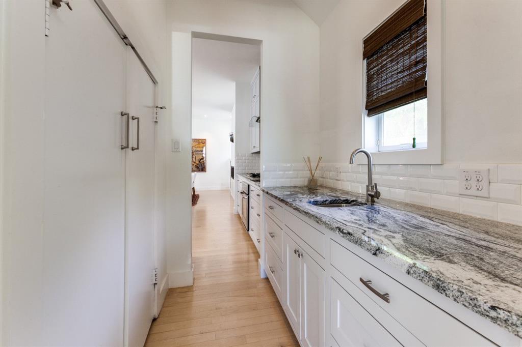 4206 Manning Lane Dallas, TX 75220 - Photo 15 of 35 a bathroom with granite countertop a sink and a wooden floor