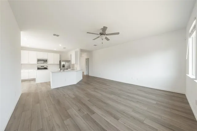 a view of a kitchen with wooden floor and a sink