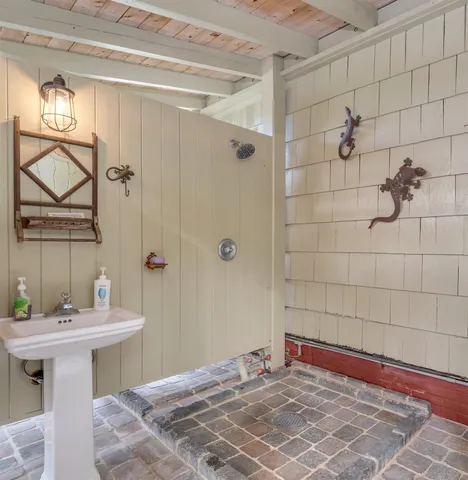 a kitchen with stainless steel appliances granite countertop a sink a stove a refrigerator cabinets and chairs