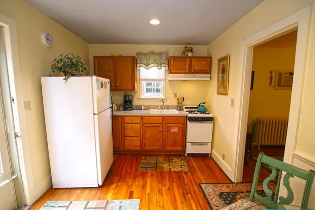 a view of a room with furniture and wooden floor