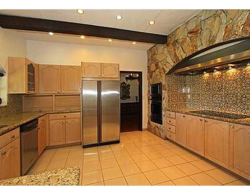 13850 Stirling Road Southwest Ranches, FL 33330 - Photo 8 of 20 a kitchen with stainless steel appliances kitchen island granite countertop a refrigerator and cabinets